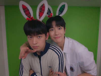 Dohyun and Woojun wear bunny ears.