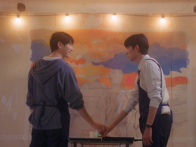 Dohyun and Woojun paint a mural.