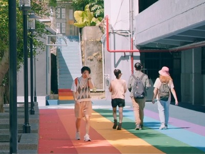 Amber walks down a rainbow path after being confronted about his gender.