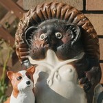 The tankuki statue is in front of the house.