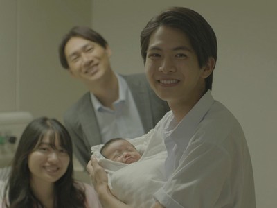 Koichi holds his baby sister in the hospital.
