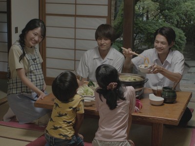 Mitsuru and Koichi enjoy a family meal.