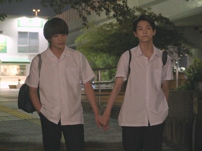 Mitsuru and Koichi hold hands in the night.