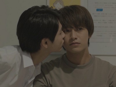 Koichi kisses Mitsuru on the cheek.