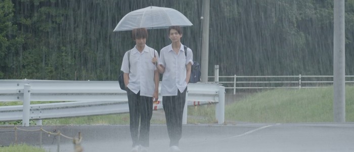 Mitsuru and Koichi walk to school on a rainy morning.
