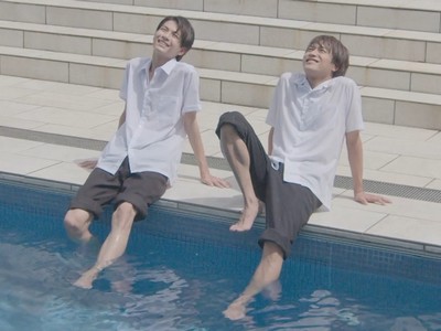 Mitsuru and Koichi lounge by the swimming pool.