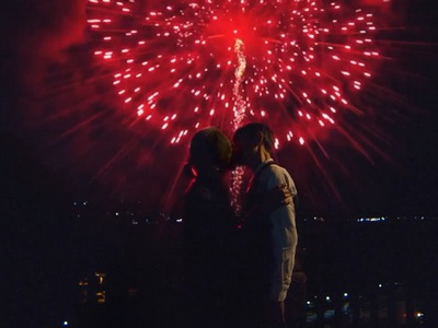 Shirasu and Buchi share a kiss with fireworks in the sky.