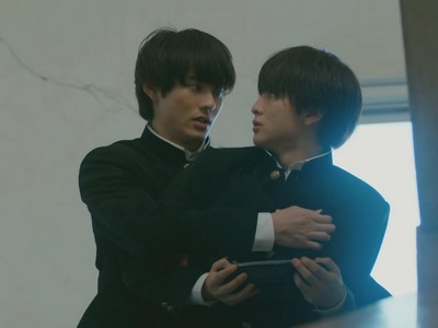 Yamato and Kakeru hug in the school stairwell.