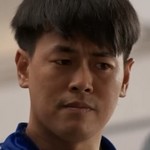 Coach Aek is portrayed by a Thai actor.
