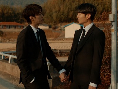 Dohoe and Juyeong hold hands.