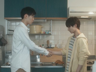 Ryota and Kazuhiro hold hands in the kitchen.