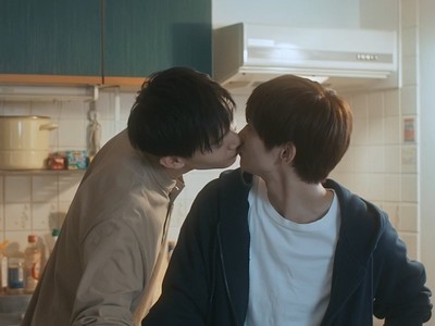 Ryota and Kazuhiro kiss in the kitchen.