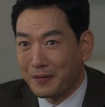Director Choi is portrayed by Lee Joo Han (이주한).