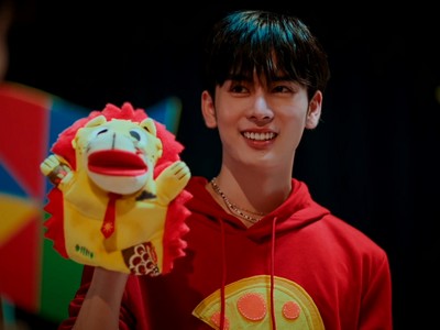 Sun holds up a puppet.