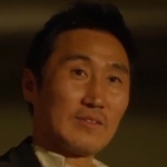 The gangster is portrayed by a Korean actor.