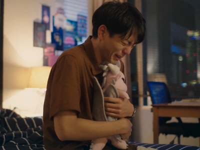 Gene cries while hugging Nubsib's doll.