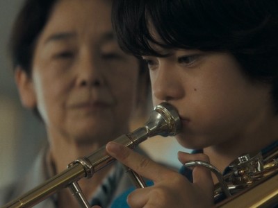 The principal teaches Minato how to play the trombone.