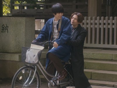 Hira and Kiyoi ride a bicycle together.