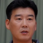 The coach is portrayed by a Korean actor.