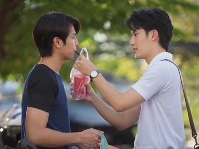 Tawan feeds a drink to Mork.