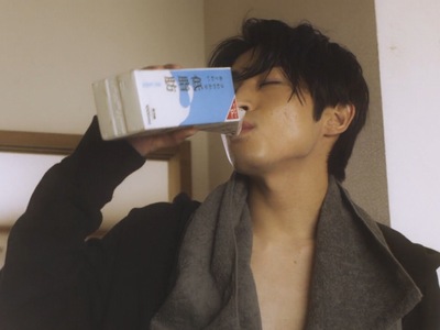 Togawa drinks milk while not wearing a shirt.