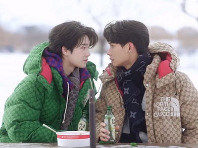 Tutor and Yim stare at each other in the outdoors.