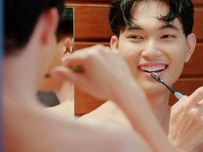 Paper and Sky are shirtless while brushing their teeth together.