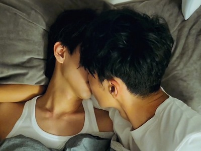 Bo Chun and Sato share a quick kiss in bed.