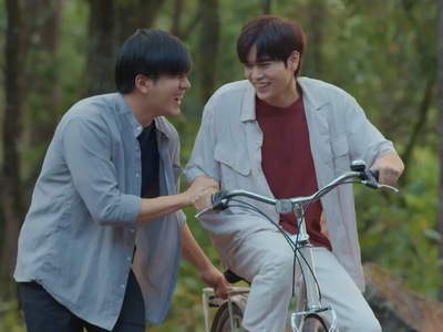 Fah and Prince ride a bicycle on their outdoor date.