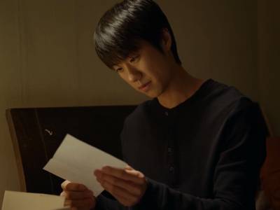 Dong Joon reads a letter from his son.