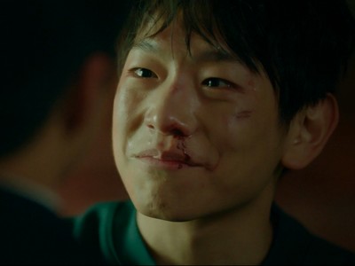 Kang Hyun smiles in the So Long, See You Tomorrow ending.
