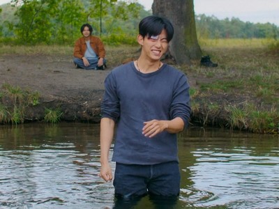 Johan washes himself in the river.