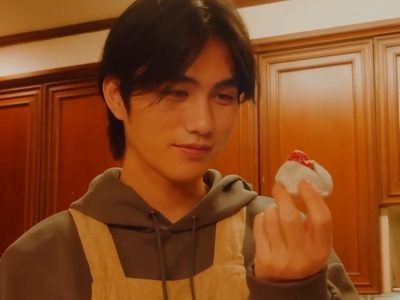 Amai stares at a dessert that he made.