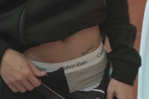 Aye flashes his Calvin Klein underwear waistband.