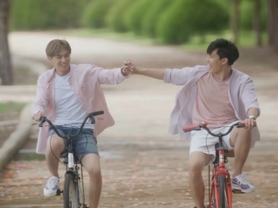 Bay and Mok hold hands as they go cycling together.