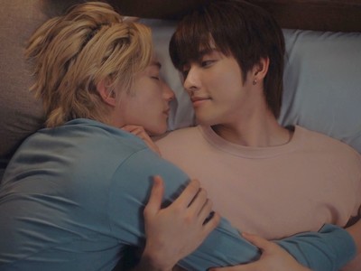 Cha and Hai cuddle in bed.