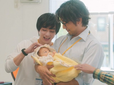 Hongou and Daichi hold a baby together.
