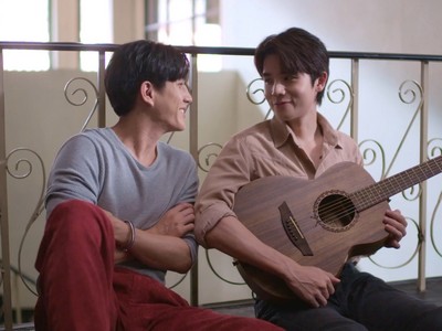 Puen plays the guitar for Talay.
